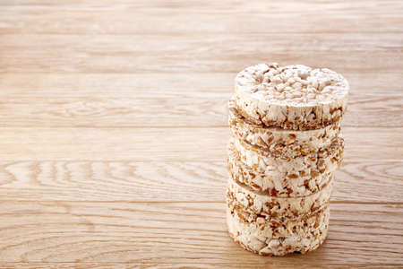 Stack of crispbreads on dark light wooden table, close-up, selective focus.の写真素材