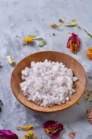 Composition of spa treatment on white background. Sea salt and flowers background, close up, top view, selective focus.の写真素材