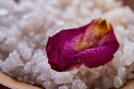 SPA concept: composition of spa treatment with natural sea salt, aromatic oil and flowers on wooden backgroundの写真素材