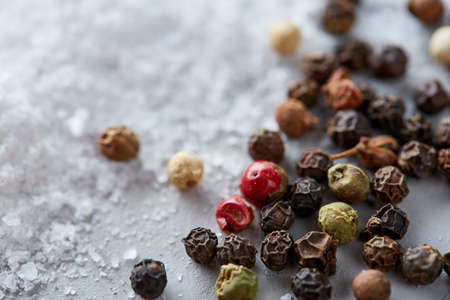Composition of bay laurel leaf with peppercorn and salt isolated on dark background, top view, close-up, selective focusの写真素材