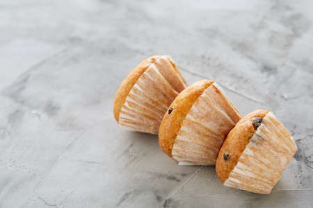 Tasty muffins arranged in pattern on light textured background, close-up, shallow depth of field, selective focus.の写真素材
