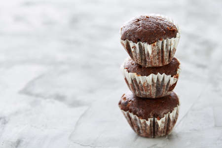Tasty muffins arranged in pattern on light textured background, close-up, shallow depth of field, selective focus.の写真素材