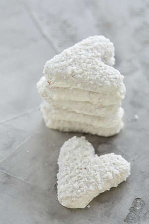 Coconat biscuits arranged in pattern on light textured background, close-up, shallow depth of field, selective focus.の写真素材