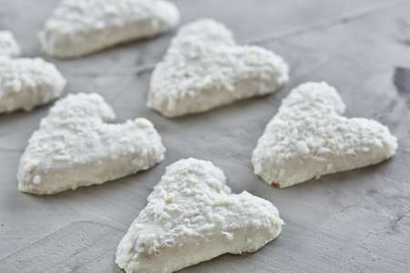 Coconat biscuits arranged in pattern on light textured background, close-up, shallow depth of field, selective focus.の写真素材