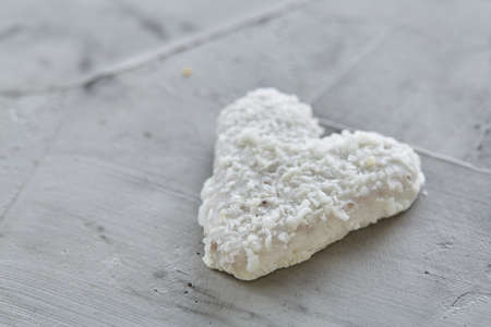 Coconat biscuits arranged in pattern on light textured background, close-up, shallow depth of field, selective focus.の写真素材
