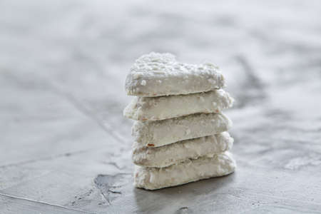Coconat biscuits arranged in pattern on light textured background, close-up, shallow depth of field, selective focus.の写真素材