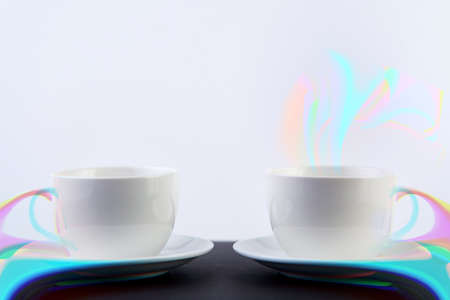 Two white porcelain teacups on black table show clean and simple design ideas, selective focusの写真素材