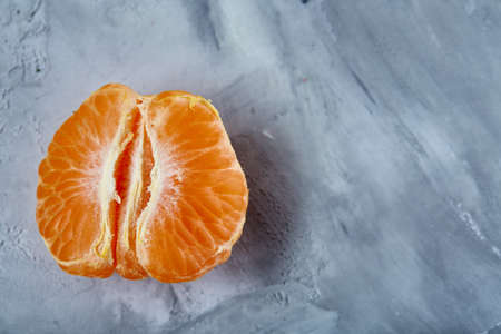 Tangerine halves isolated over light grey textured background, top view, selective focus.の写真素材