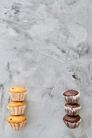 Tasty muffins arranged in pattern on light textured background, close-up, shallow depth of field,...