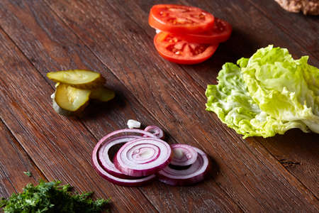 Tasty hamburger ingredients are laid out separately from above, beautifully harmoniously, close-up, top viewの写真素材