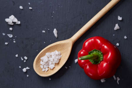 Vegetarian still life with fresh grape tomatoes, pepper and salt in wooden spoon on wooden background, selective focusの写真素材
