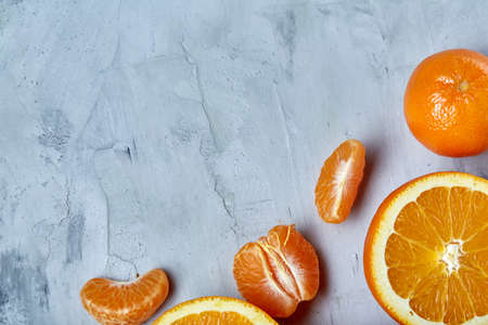 Variety of fresh citrus fruits for making juice or smoothie over light textured background, top view, selective focus.の写真素材