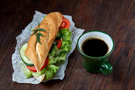 Lunch sandwich with cheese and vegetables served with citrus and coffee, selective focus, close-up, top viewの写真素材