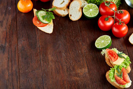 Lunch sandwich with cheese and vegetables served with citrus and coffee, selective focus, close-up, top viewの写真素材