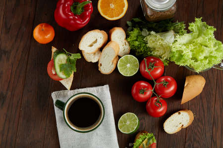 Healthy breakfast with cup of coffee, sandwich, fruits and vegetables, close-up, selective focus, top view.の写真素材
