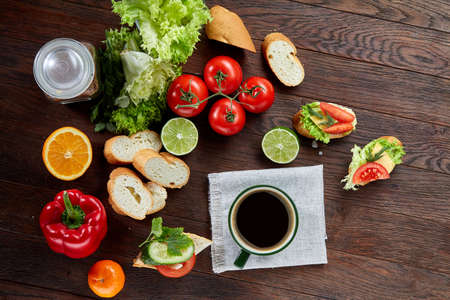Healthy breakfast with cup of coffee, sandwich, fruits and vegetables, close-up, selective focus, top view.の写真素材