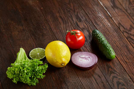 Fresh vegetables still life. Veges lined up on a wooden background, top view, close-up, selective focus, copy space.の写真素材