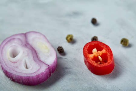 Chopped onion, red hot pepper and spice isolated on white background, top view, close-up, selective focusの写真素材