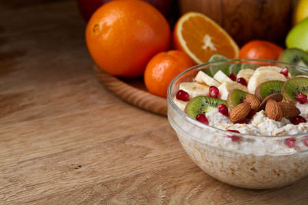 Breakfast still life with oatmeal porridge and fruits, top view, selective focus, shallow depth of field.の写真素材