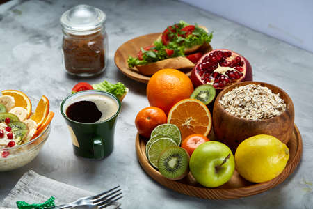 Breakfast still life with oatmeal porridge, fruits and coffee cup, top view, selective focus, shallow depth of field.の写真素材