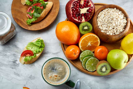 Breakfast still life with oatmeal porridge, fruits and coffee cup, top view, selective focus, shallow depth of field.の写真素材