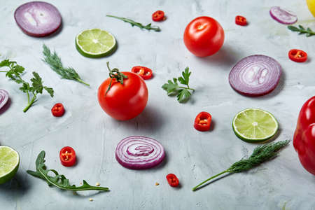 Seamlesly spread chopped onion, red hot pepper and spice isolated on white background, top view, close-up, selective focus. Copy space for your text. Gourmet condiment. Healthy food background.の写真素材