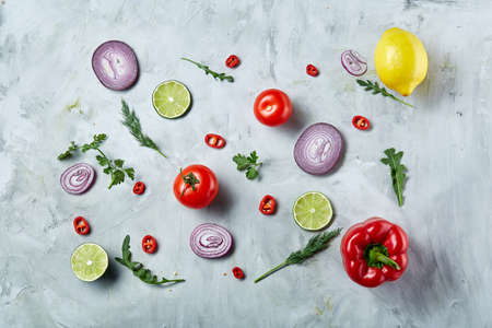 Seamlesly spread chopped onion, red hot pepper and spice isolated on white background, top view, close-up, selective focus. Copy space for your text. Gourmet condiment. Healthy food background.の写真素材