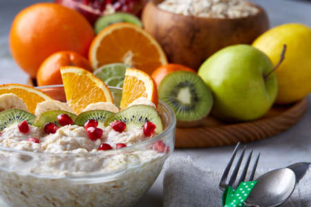 Breakfast still life with oatmeal porridge and fruits, top view, selective focus, shallow depth of field.の写真素材