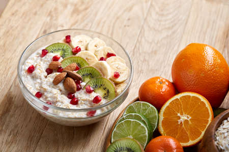 Breakfast still life with oatmeal porridge and fruits, top view, selective focus, shallow depth of field.の写真素材