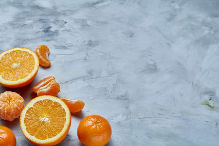 Variety of fresh citrus fruits for making juice or smoothie over light textured background, top view, selective focus.の写真素材