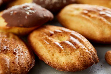 Tasty almond cookies arranged in the shape of fan decorated with almonds on white textured...