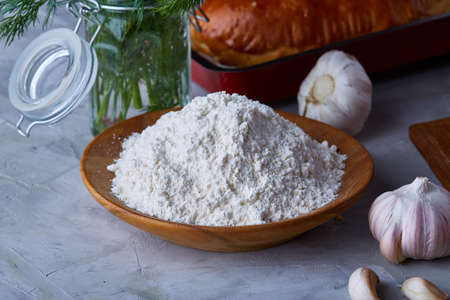 Preparation for cooking, plate with seasalt ordanized with garlic and dill over white textured...