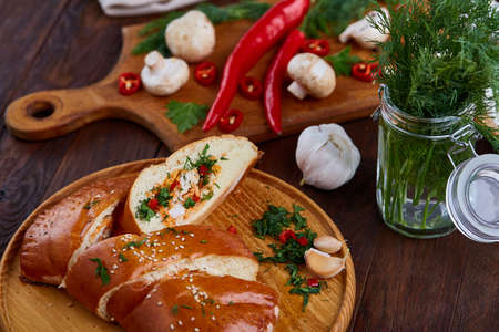 Countryside cuisine still life with tasty homemade pie, fresh mushrooms, hot pepper, garlic and...