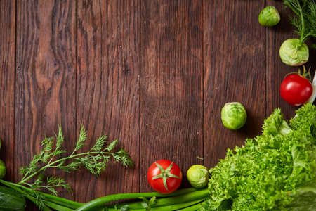 The round frame made of vegetables and herbs on a white textured background, copy space, top view,...