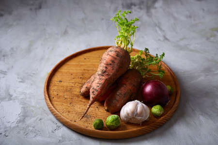Colorful various of organic farm vegetables with fresh carrots, garlic, onion, brussel sprout on...