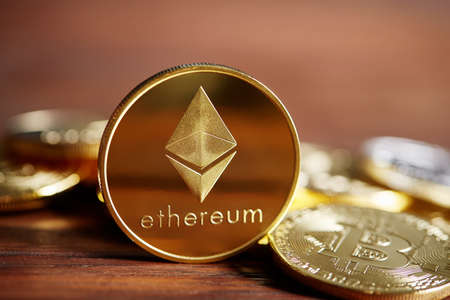 Ethereum on the pile of cryptocurrency over wooden table as most important cryptocurrency concept, close-up, selective focus. Cryptocurrency mining. Virtual business. Electornic commerce. Banking monetary. Cryptocurrency diversification.の写真素材