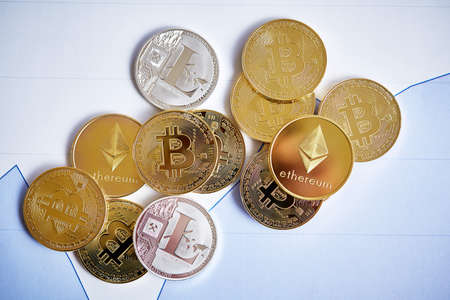 Different cryptocurrency on the chart background, close-up, shallow depth of field. Some copy space. Bitcoin, litecion and ethereum over stock exchange diagram. Cryptocurrency mining. Virtual business. Electornic commerce. Banking monetary.の写真素材