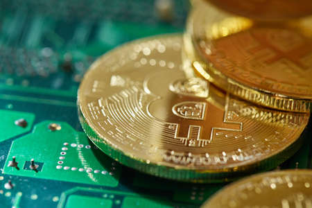 Stack of cryptocurrencies arranged on the motherboard. Bitcoin as most important cryptocurrency...