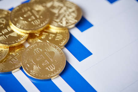Different cryptocurrency on the chart background, close-up, shallow depth of field. Some copy space....