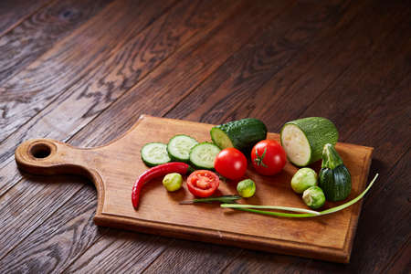 Fresh vegetables on the cutting board over wooden background, selective focus, shallow depth of...
