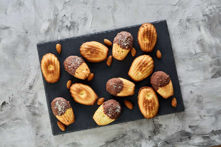 Freshly baked almond cookies on cooking tray over vintage wooden background, top view, selective...