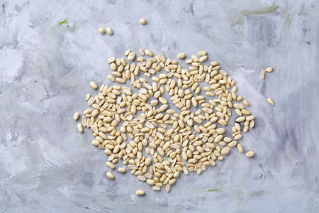 Pile of peelled peanuts isolated on white textured background, background, top view, close-up,...