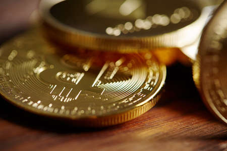 Digital cryptocurrencys bitcoin, ethereum and litecoin on the wooden background. Cryptocurrency concept, close-up, selective focus. Cryptocurrency mining. Virtual business. Electornic commerce. Banking monetary. Cryptocurrency diversification.の写真素材