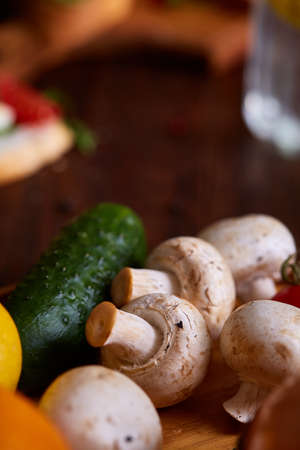 Breakfast still life with sandwiches, quail eggs, spicies and fresh fruits and vegetables on rustic wooden background, selective focus. Gourmet buckish starter. Delicious excuisite appetizer. Sofisticated cuisine. Food concept.の写真素材
