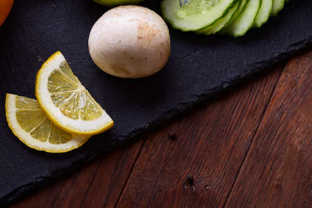 Breakfast sandwich with homemade paste, vegetables and fresh greenson wooden cutting board over rustic background, shallow depth of field, close-up. Delicious morning appetizer. Gourmet bruschetta. Healthy eating concept.の写真素材