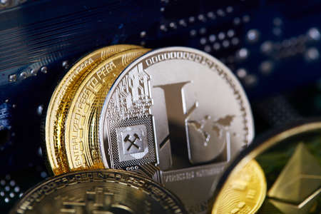 Digital cryptocurrencys Bitcoin, Ethereum, Litecoin on motherboard. Cryptocurrency concept, close-up
