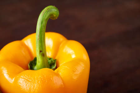 Combination of fresh organic green, yellow and red pepper on rustic wooden background, top view, close-up, selective focus. Heap of organic bell peppers. Studio shot. Fresh tasty salad ingredient. Healthy food concept.の写真素材