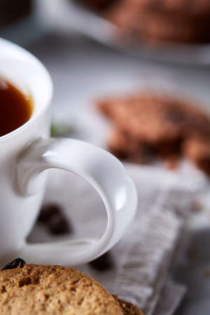 Breakfast background with mug of fresh coffee, homemade oatmeal cookies, grind coffeeの写真素材