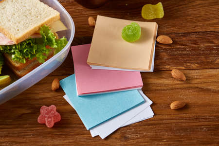 Concept of school lunch break with healthy lunch box and school supplies on wooden desk, selective...