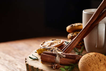 Sweet assortment of biscuits on a round wood log over rustic wooden background, close-up, selective...
